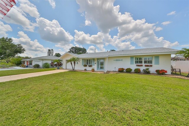 1224 W Del Webb Blvd, Sun City Center, FL 33573 - ranch-style home with concrete driveway, a garage, a front yard, and stucco siding