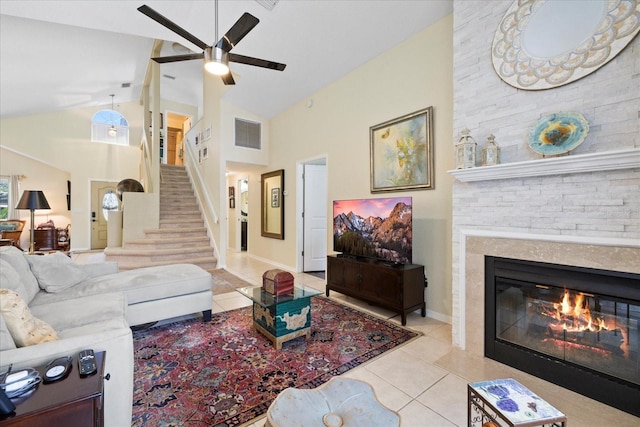 4047 Eagle Cove W Dr, Palm Harbor, FL 34685 - tiled living room with a ceiling fan, a fireplace, stairs, and high vaulted ceiling
