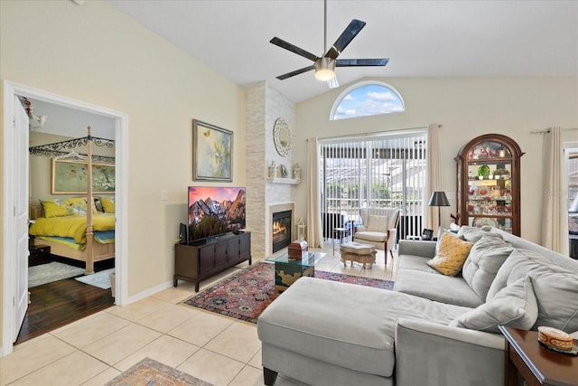 4047 Eagle Cove W Dr, Palm Harbor, FL 34685 - living room with ceiling fan, lofted ceiling, light tile patterned floors, and a large fireplace