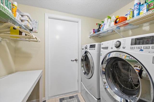4047 Eagle Cove W Dr, Palm Harbor, FL 34685 - laundry area with washing machine and clothes dryer, a textured ceiling, and light tile patterned floors