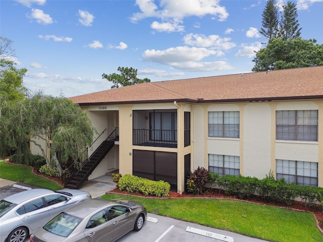 3389 Crystal Ct E J, Unit J, Palm Harbor, FL 34685 - view of building exterior with uncovered parking and stairway
