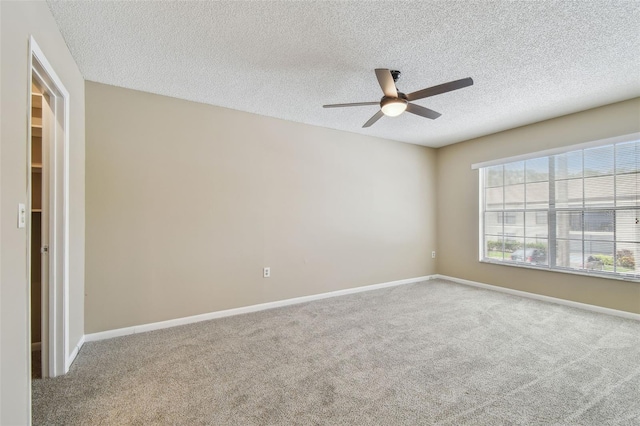 3389 Crystal Ct E J, Unit J, Palm Harbor, FL 34685 - spare room featuring ceiling fan, carpet flooring, a textured ceiling, and baseboards
