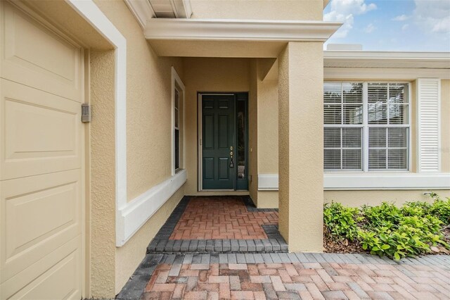27427 Mistflower Dr, Wesley Chapel, FL 33544 - view of exterior entry featuring stucco siding