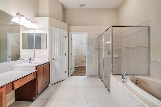 27427 Mistflower Dr, Wesley Chapel, FL 33544 - full bath featuring a spacious closet, vanity, a stall shower, a garden tub, and tile patterned flooring