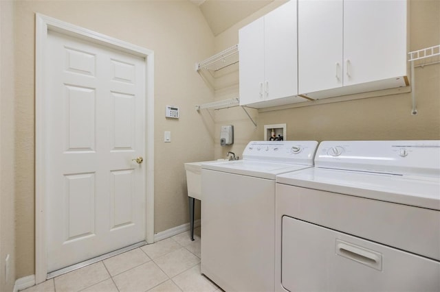 27427 Mistflower Dr, Wesley Chapel, FL 33544 - laundry room featuring cabinet space, washer and dryer, light tile patterned floors, and baseboards