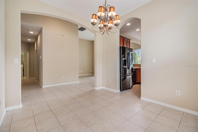 27427 Mistflower Dr, Wesley Chapel, FL 33544 - empty room with arched walkways, light tile patterned floors, a chandelier, recessed lighting, and baseboards