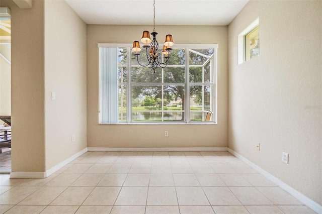 27427 Mistflower Dr, Wesley Chapel, FL 33544 - unfurnished dining area featuring a chandelier, healthy amount of natural light, and baseboards
