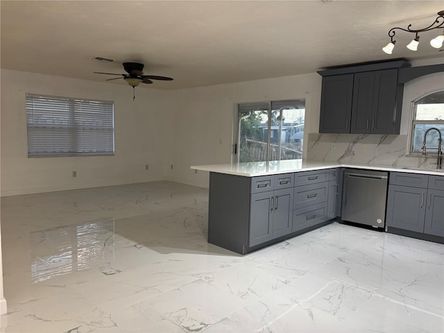 6820 26th St W, Bradenton, FL 34207 - kitchen with dishwasher, a peninsula, ceiling fan, light marble finish floors, and light countertops