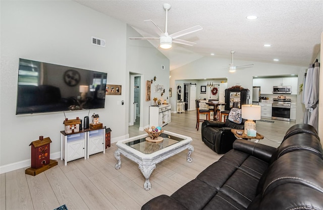 7547 Landmark Dr, Spring Hill, FL 34606 - living area with ceiling fan, vaulted ceiling, a textured ceiling, light wood-style floors, and recessed lighting