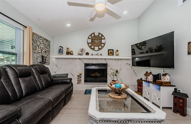 7547 Landmark Dr, Spring Hill, FL 34606 - living area featuring a ceiling fan, lofted ceiling, and a high end fireplace