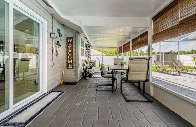 7547 Landmark Dr, Spring Hill, FL 34606 - sunroom featuring outdoor dining area