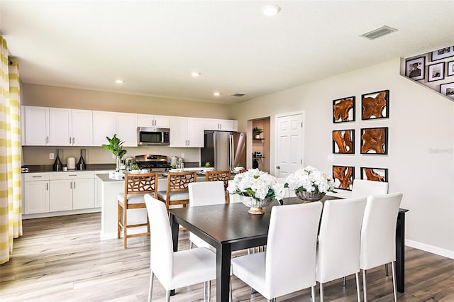 1217 Tidal St, Haines City, FL 33844 - dining area with light wood-type flooring, recessed lighting, and baseboards