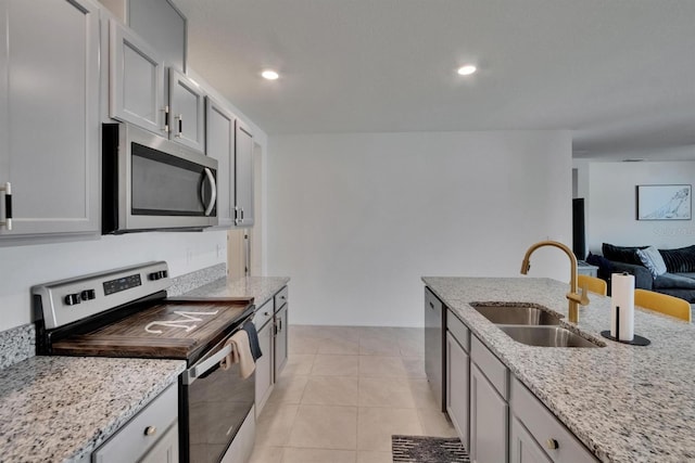 3628 Diving Dove Ln, Bartow, FL 33830 - kitchen featuring appliances with stainless steel finishes, a sink, open floor plan, light stone countertops, and recessed lighting