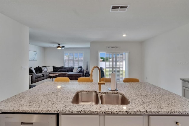 3628 Diving Dove Ln, Bartow, FL 33830 - kitchen featuring a sink, white cabinets, light stone countertops, and open floor plan