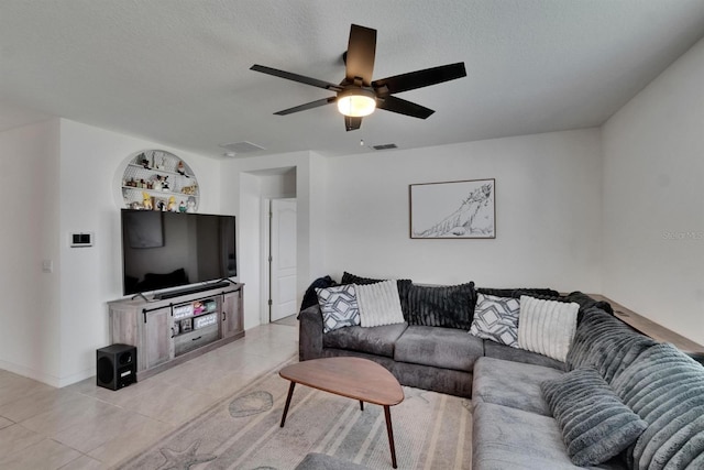 3628 Diving Dove Ln, Bartow, FL 33830 - living room with light tile patterned floors, ceiling fan, a textured ceiling, and baseboards