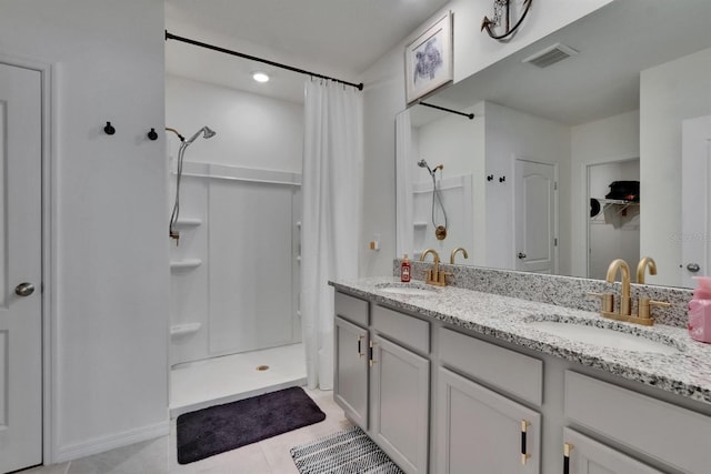3628 Diving Dove Ln, Bartow, FL 33830 - full bathroom with curtained shower, tile patterned floors, double vanity, and a walk in closet
