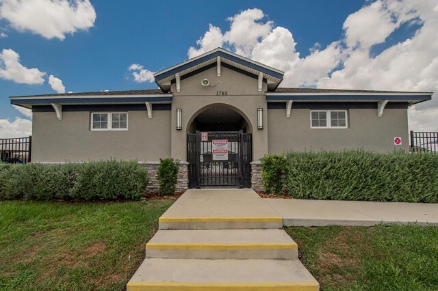 3628 Diving Dove Ln, Bartow, FL 33830 - mediterranean / spanish home featuring stucco siding, a gate, and stone siding