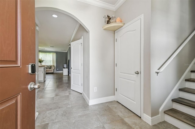 10512 Scenic Hollow Dr, Riverview, FL 33578 - foyer with crown molding, baseboards, arched walkways, and stairway