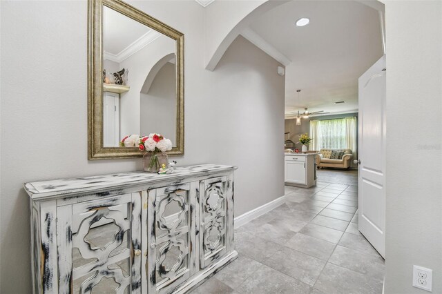 10512 Scenic Hollow Dr, Riverview, FL 33578 - hallway with ornamental molding, arched walkways, baseboards, and light tile patterned floors