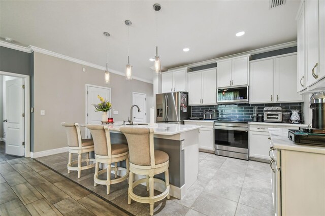 10512 Scenic Hollow Dr, Riverview, FL 33578 - kitchen featuring stainless steel appliances, ornamental molding, backsplash, light countertops, and a kitchen breakfast bar
