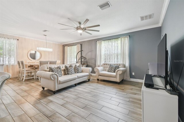10512 Scenic Hollow Dr, Riverview, FL 33578 - living area featuring a ceiling fan, crown molding, and light wood-style flooring