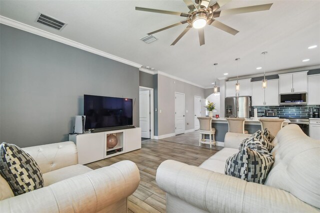 10512 Scenic Hollow Dr, Riverview, FL 33578 - living room featuring ornamental molding, light wood-style flooring, a ceiling fan, recessed lighting, and baseboards