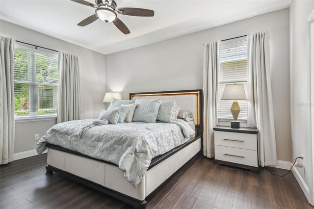 10512 Scenic Hollow Dr, Riverview, FL 33578 - bedroom with dark wood-type flooring, baseboards, and ceiling fan