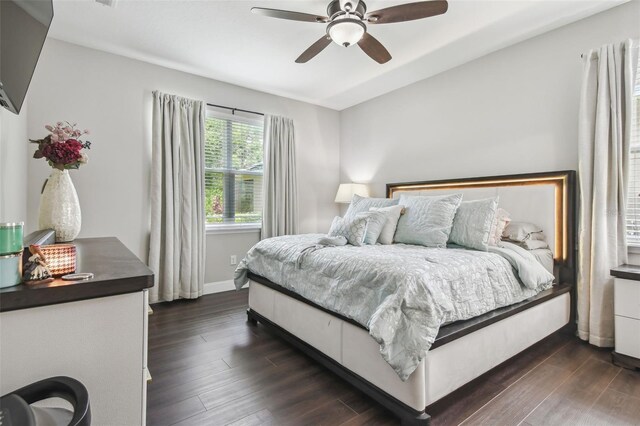 10512 Scenic Hollow Dr, Riverview, FL 33578 - bedroom featuring dark wood-style floors, ceiling fan, and baseboards