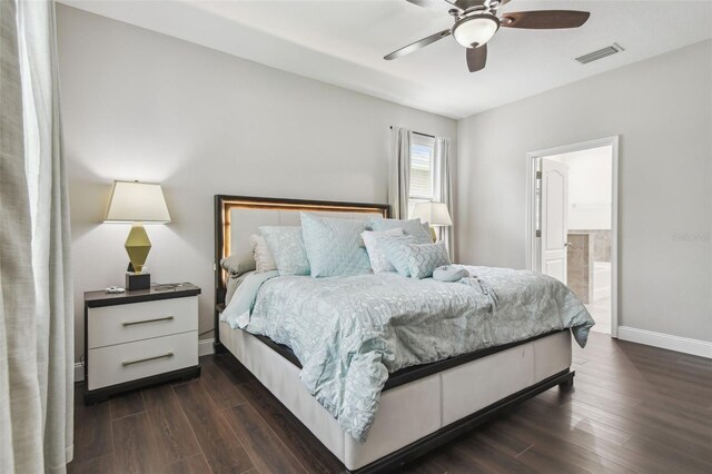 10512 Scenic Hollow Dr, Riverview, FL 33578 - bedroom featuring dark wood-type flooring, baseboards, connected bathroom, and ceiling fan