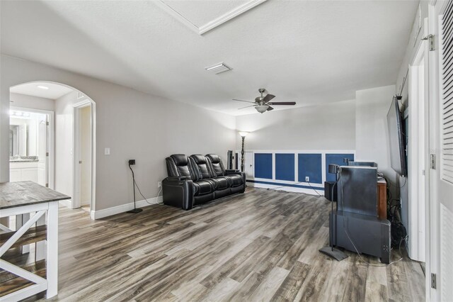 10512 Scenic Hollow Dr, Riverview, FL 33578 - living area with arched walkways, wood finished floors, ceiling fan, and baseboards