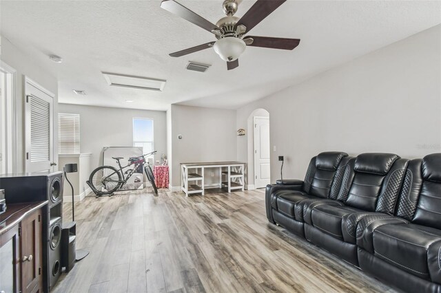 10512 Scenic Hollow Dr, Riverview, FL 33578 - living room with attic access, ceiling fan, wood finished floors, arched walkways, and baseboards