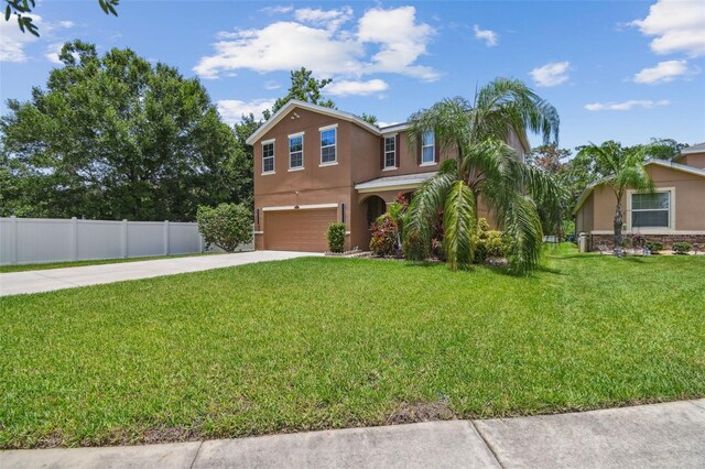 10512 Scenic Hollow Dr, Riverview, FL 33578 - view of front facade featuring stucco siding, an attached garage, and driveway