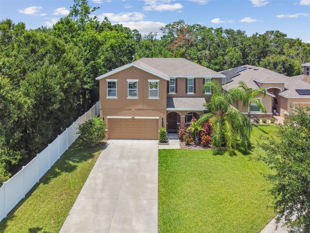 10512 Scenic Hollow Dr, Riverview, FL 33578 - traditional-style home with concrete driveway, an attached garage, and stucco siding