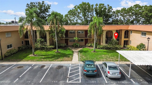 4500 E Bay Dr Unit 106, Clearwater, FL 33764 - view of property featuring uncovered parking