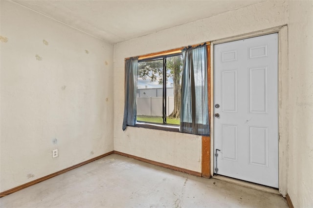 4500 E Bay Dr Unit 106, Clearwater, FL 33764 - empty room with unfinished concrete floors and baseboards