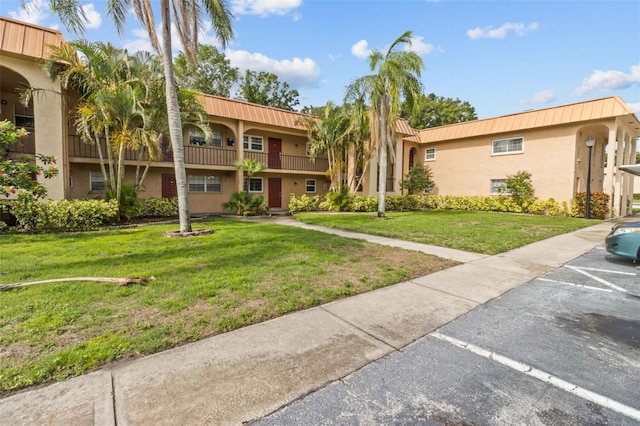 4500 E Bay Dr Unit 106, Clearwater, FL 33764 - view of property featuring uncovered parking