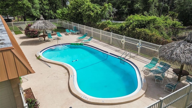 4500 E Bay Dr Unit 106, Clearwater, FL 33764 - community pool with a patio area, a fenced backyard, and view of scattered trees