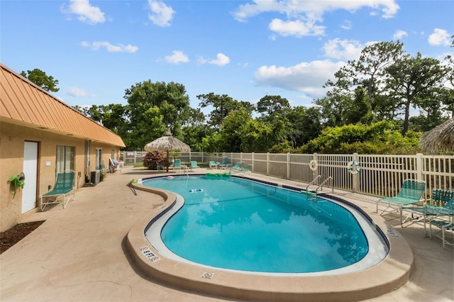 4500 E Bay Dr Unit 106, Clearwater, FL 33764 - community pool with a patio and view of wooded area