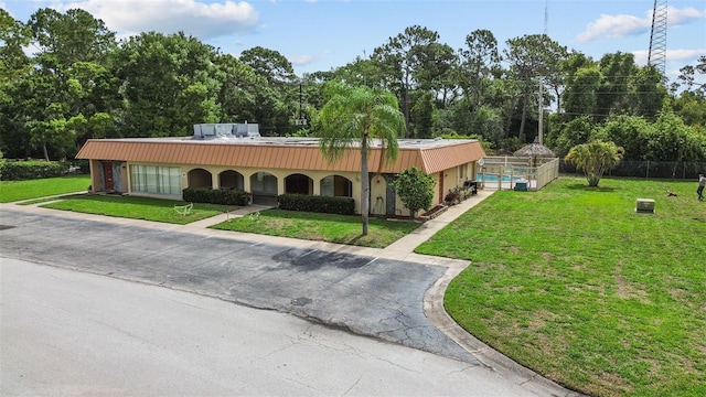 4500 E Bay Dr Unit 106, Clearwater, FL 33764 - view of front facade with an outdoor pool and metal roof