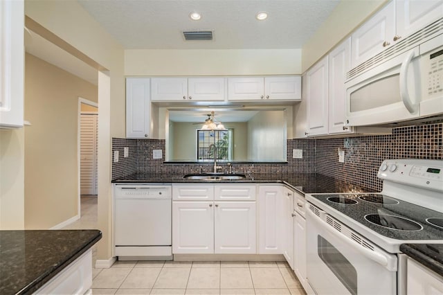 340 Causeway Blvd Unit 105, Dunedin, FL 34698 - kitchen with white appliances, a sink, white cabinetry, a ceiling fan, and backsplash
