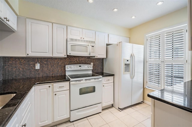 340 Causeway Blvd Unit 105, Dunedin, FL 34698 - kitchen featuring white appliances, white cabinets, light tile patterned floors, backsplash, and recessed lighting