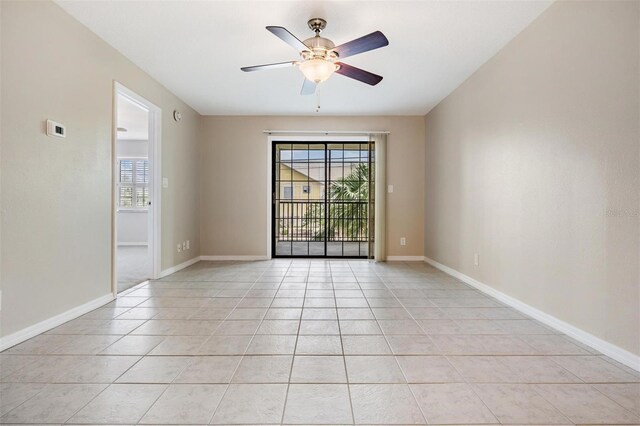 340 Causeway Blvd Unit 105, Dunedin, FL 34698 - unfurnished room with light tile patterned floors, ceiling fan, and baseboards