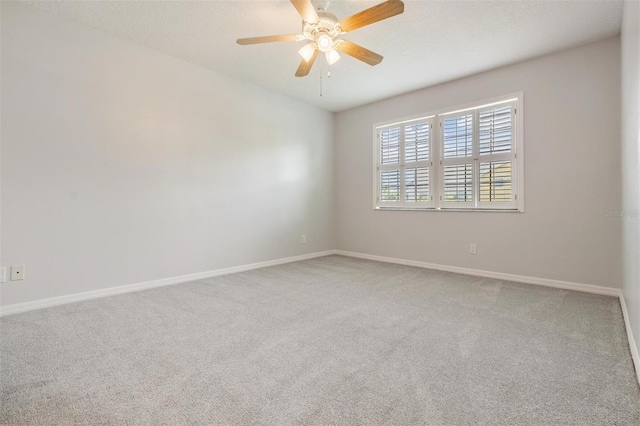 340 Causeway Blvd Unit 105, Dunedin, FL 34698 - carpeted spare room with a ceiling fan and baseboards