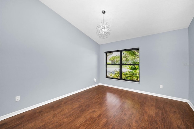 2459 Parkstream Ave, Clearwater, FL 33759 - unfurnished room with dark wood-style floors, lofted ceiling, and a chandelier