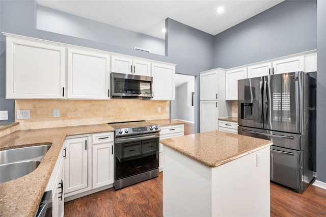2459 Parkstream Ave, Clearwater, FL 33759 - kitchen with stainless steel appliances, light stone counters, white cabinetry, dark wood-style floors, and recessed lighting