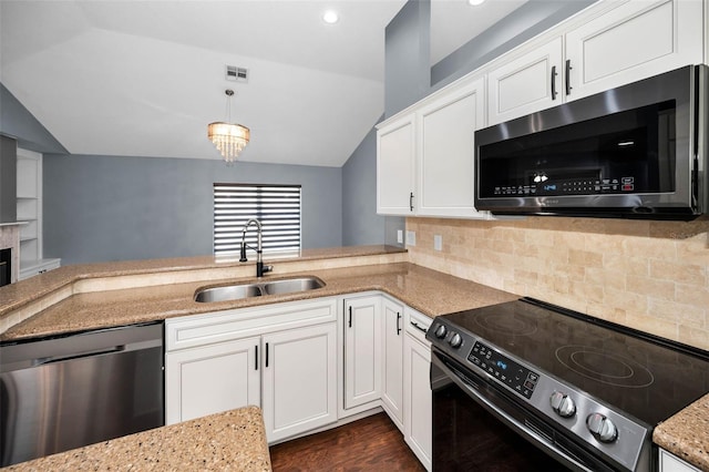 2459 Parkstream Ave, Clearwater, FL 33759 - kitchen with stainless steel appliances, vaulted ceiling, light stone counters, white cabinets, and backsplash