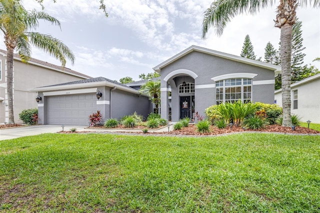 8814 N River Rd, Tampa, FL 33635 - view of front of home with stucco siding, an attached garage, driveway, and a front lawn