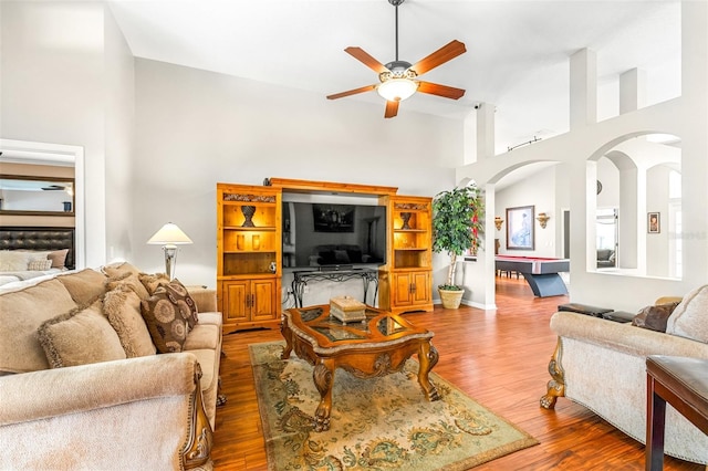 8814 N River Rd, Tampa, FL 33635 - living room featuring ceiling fan, wood finished floors, and arched walkways
