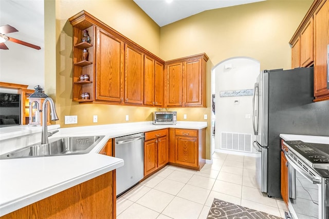 8814 N River Rd, Tampa, FL 33635 - kitchen with stainless steel appliances, arched walkways, a sink, ceiling fan, and light countertops