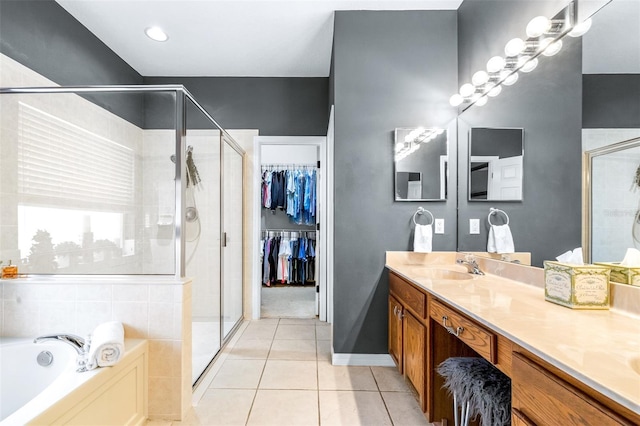 8814 N River Rd, Tampa, FL 33635 - full bathroom featuring vanity, a shower stall, a garden tub, tile patterned floors, and a spacious closet